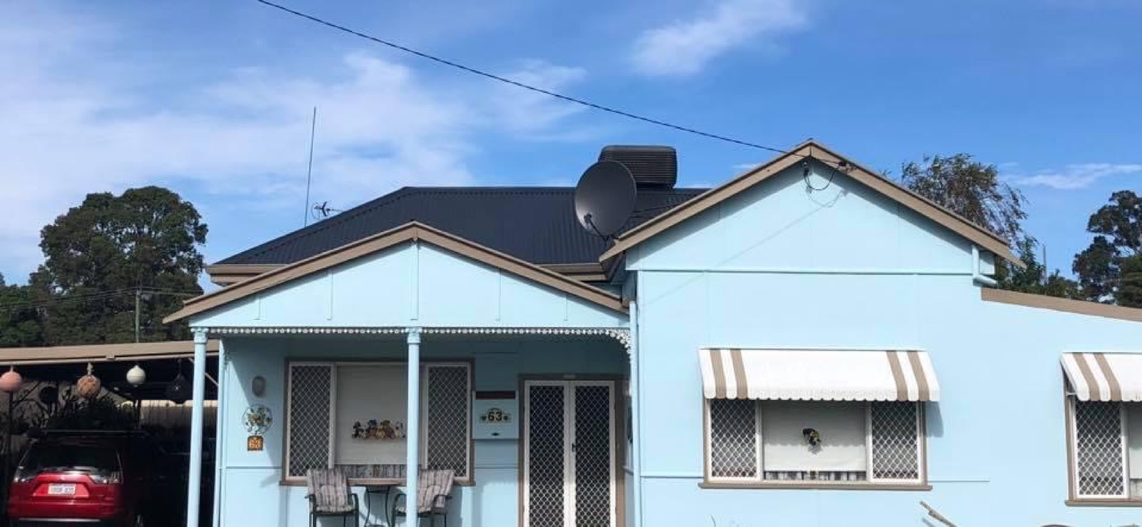 Blue home with restored roof