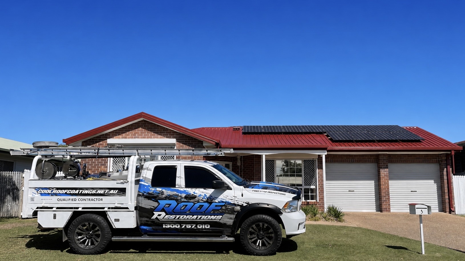 Cool Roof Coatings work truck parked in front of a restored red roof home