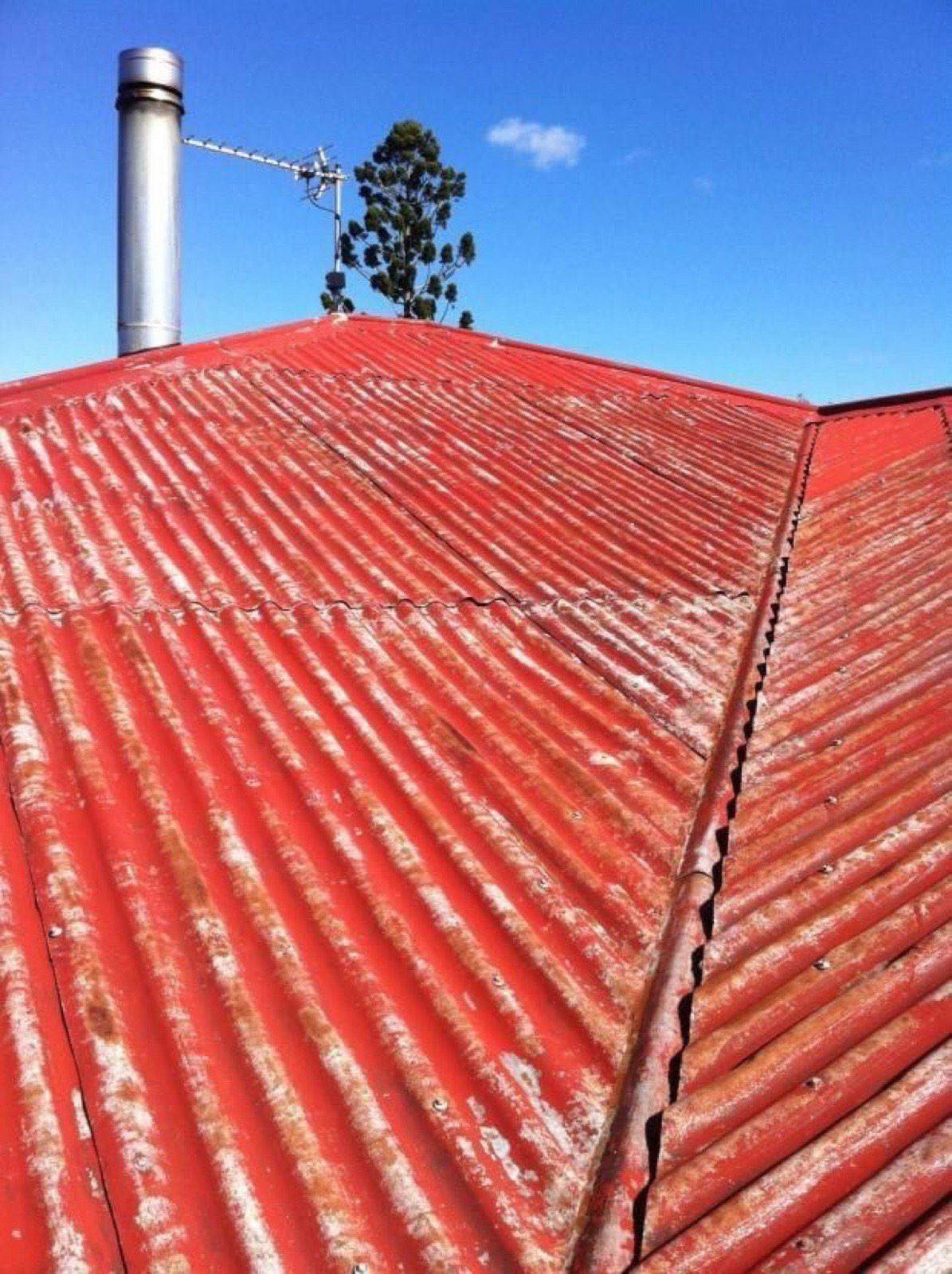 Rusty red galv roof before recoating